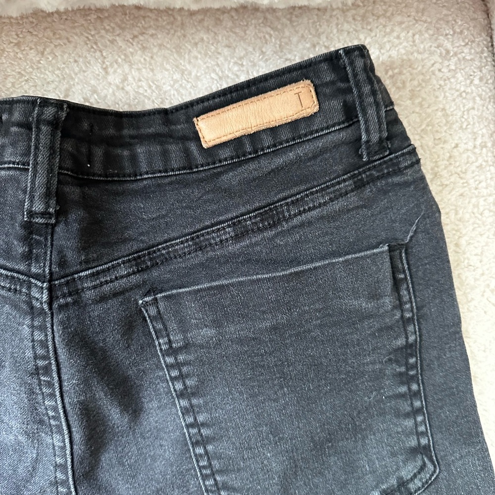 Black jeans with a split hem